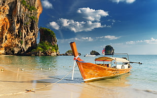 brown boat on body of water during daytime HD wallpaper